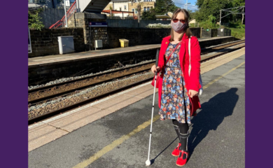 Chloe Tear wearing a mask on a train station platform