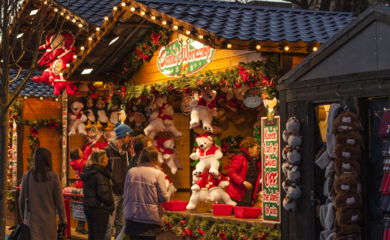 Image of a hut with people walking in front of it at a Christmas market