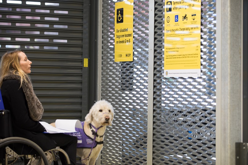 Helen Dolphin in a car park with her assistance dog