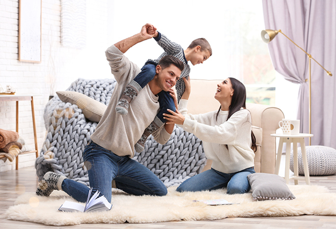 A couple playing with their child