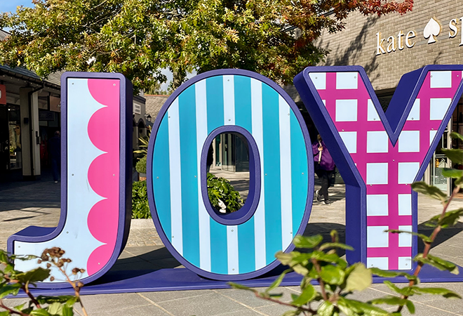"Individual large sized letters spelling out the word JOY"