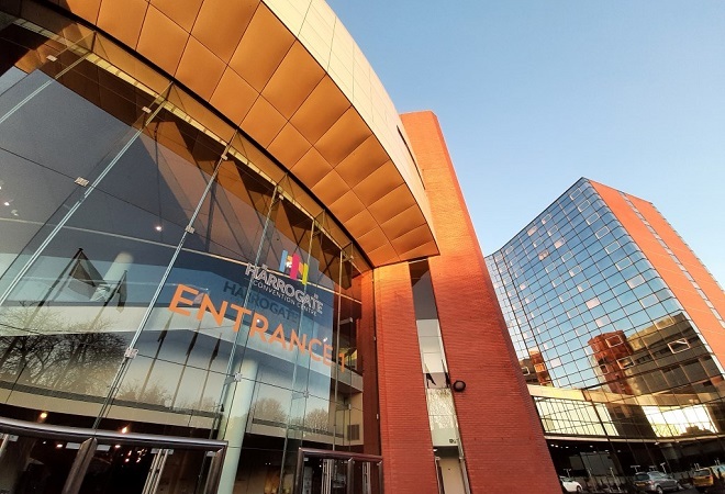 "A photograph of Harrogate Convention Centre from the outside looking up towards the building"