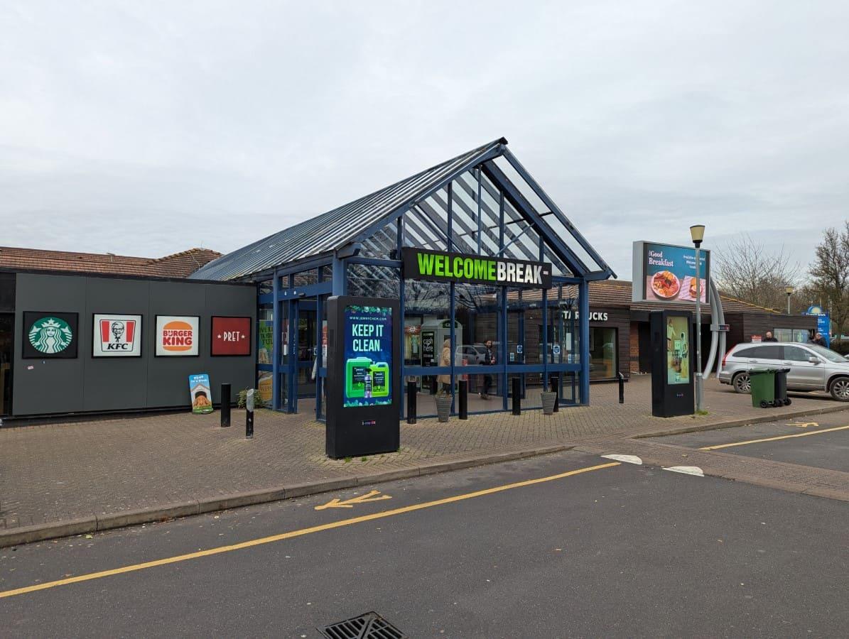 A picture showing the front of the M40 - Warwick Services - Southbound - Welcome Break 2 with a car outside