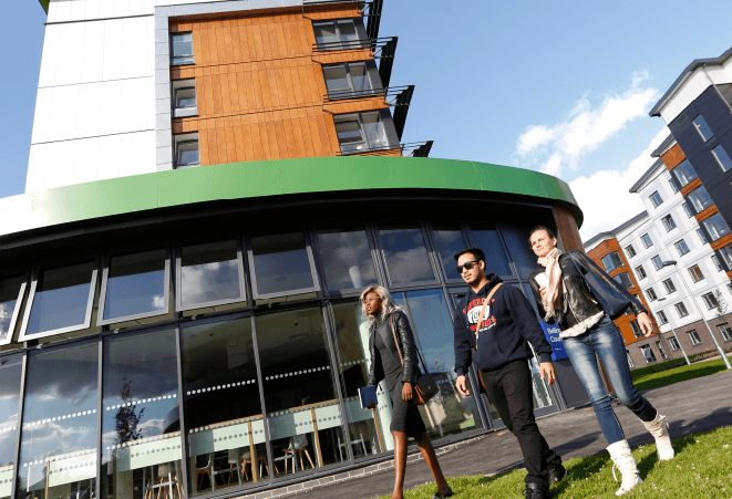 Students walking in the sun on the university campus