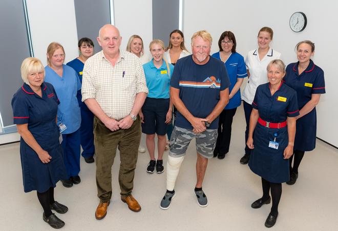 "Staff and patients standing in hospital setting"
