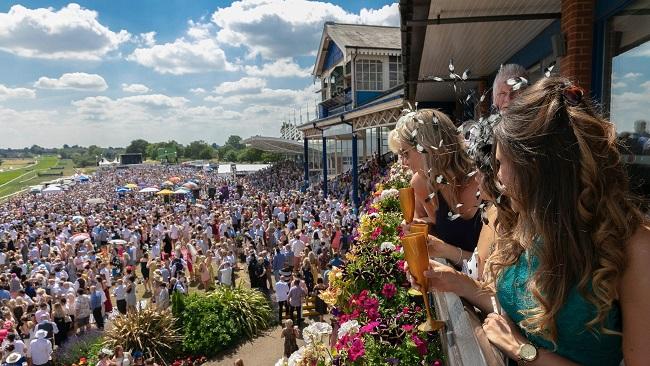 "Shot of the crowd cheering the horses on"