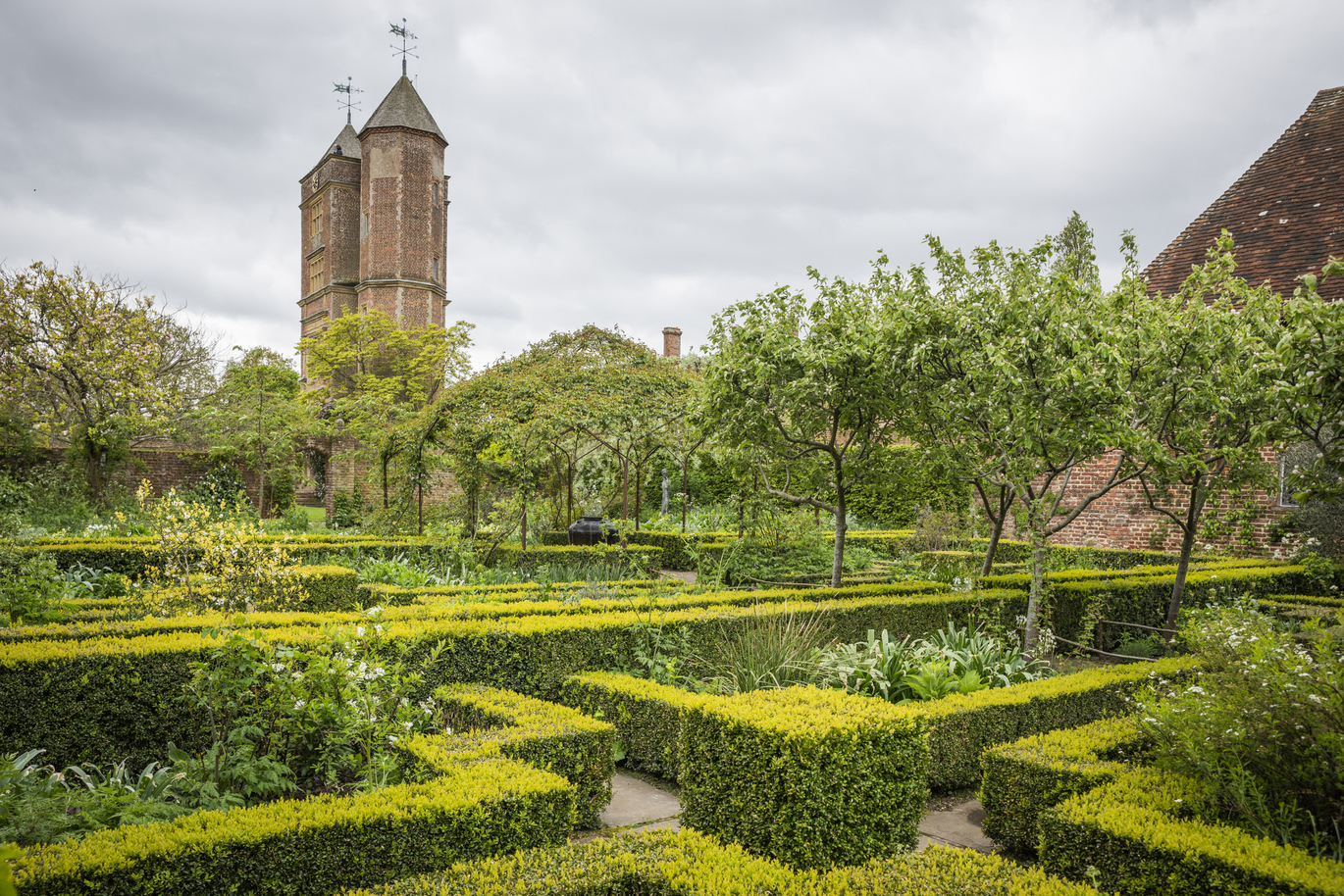 View of the White Garden and Elizabethan Tower in April at the 16th century Sissinghurst Castle Garden.