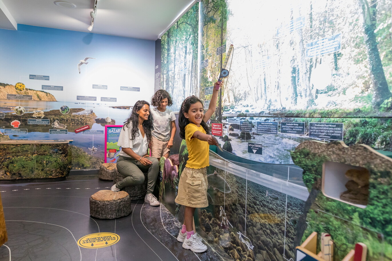 "A femme and two children play within one of the exhibition spaces at the National Park Centre"