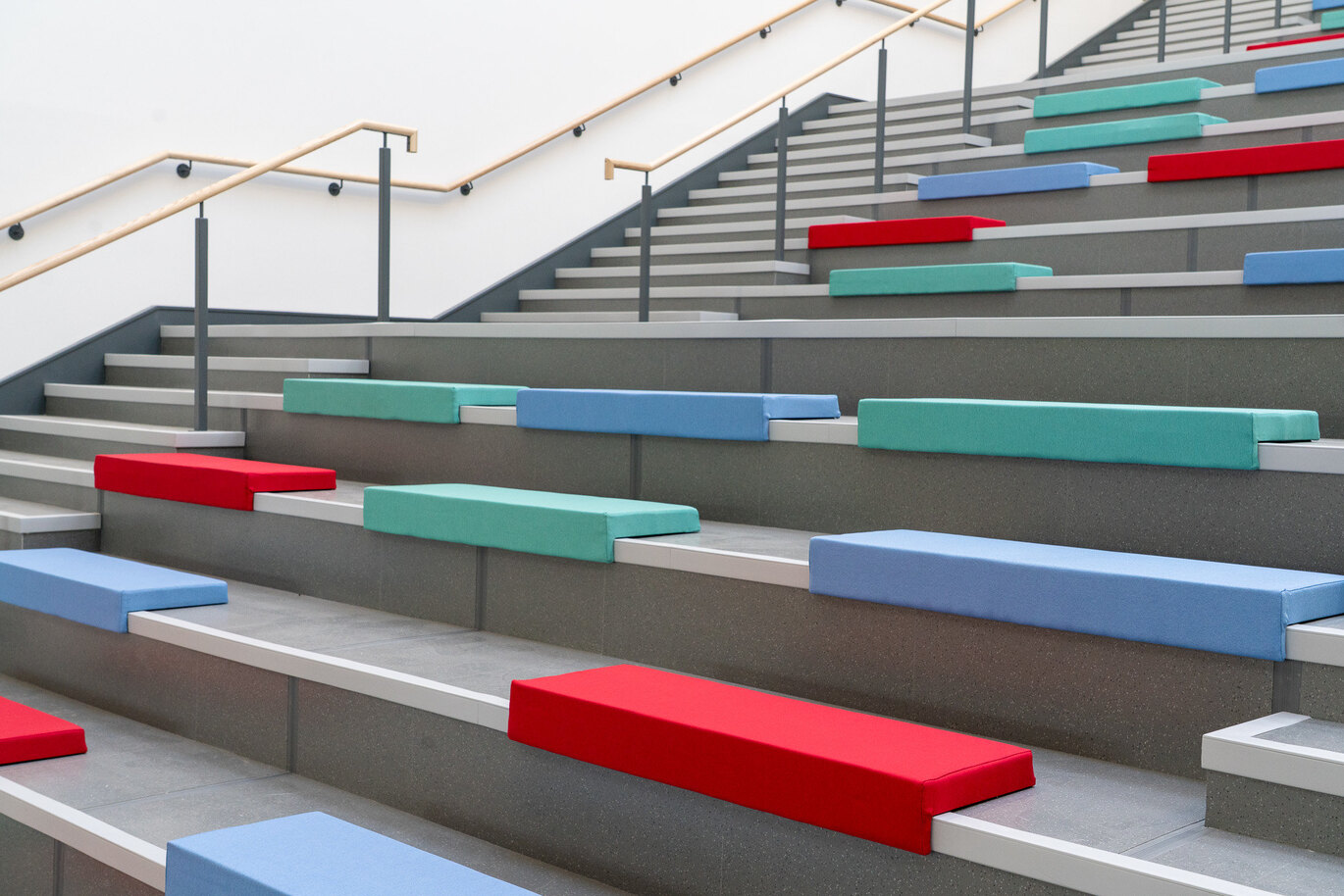 Tiered seating along steps with brightly coloured cushions
