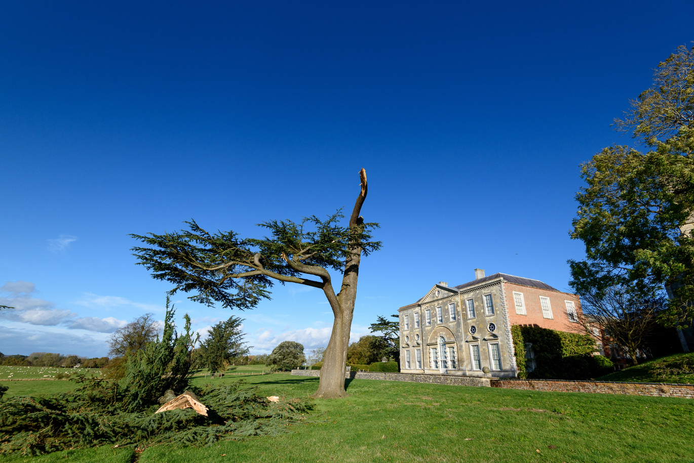 Distant exterior shot of the 18th century house at Claydon surrounded by fields and trees.