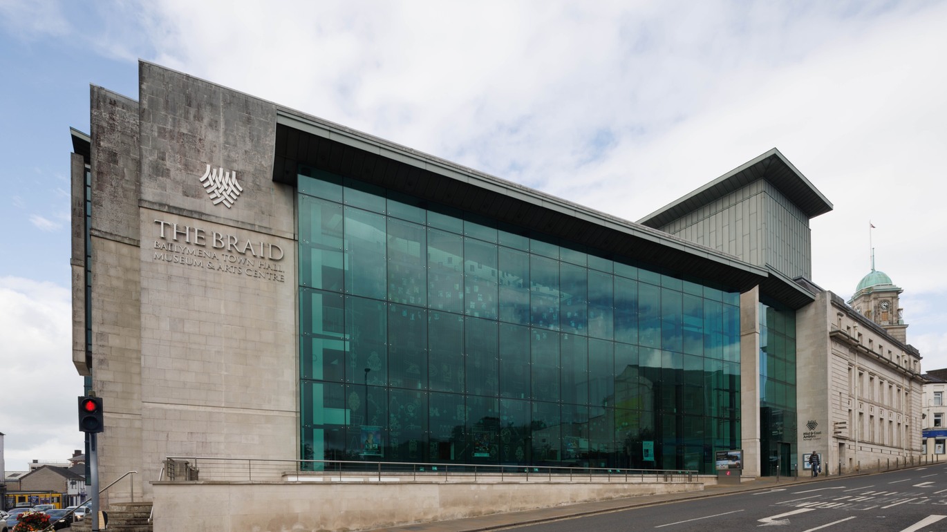 "The Braid building from the exterior with a combination of cement bricks and glass windows"