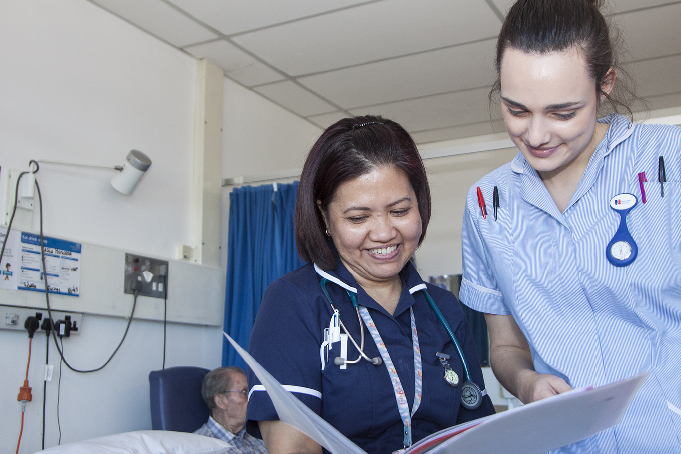 Photo of staff looking at information in a folder