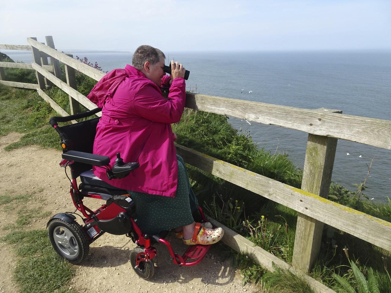 "person using binoculars to look out to the sea"