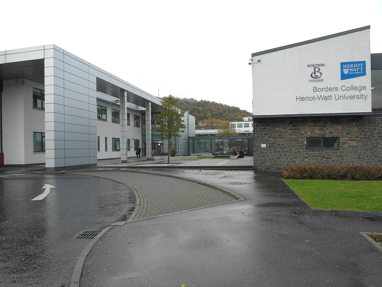 "University building with large sign on building to right reading Borders College"