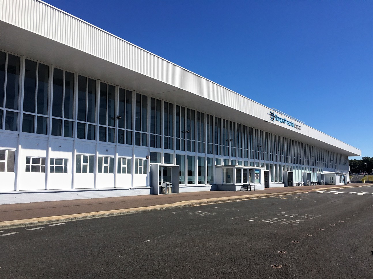 "Glasgow Prestwick Airport entrance with a zebra crossing in front of the building"