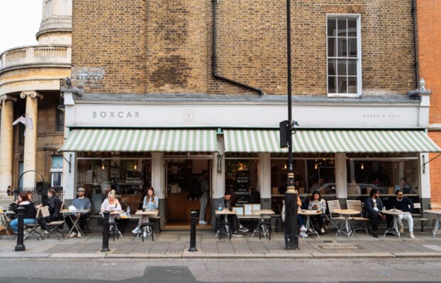 Boxcar Cafe, customers drinking and eating outside the store.