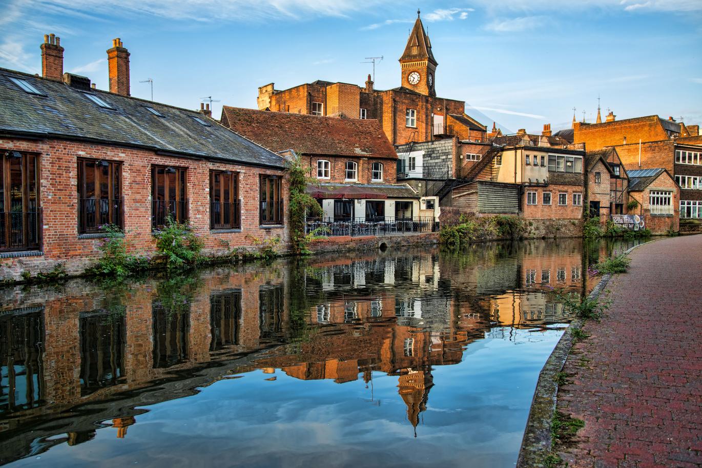 "Newbury buildings reflecting on the canal running through the Town"