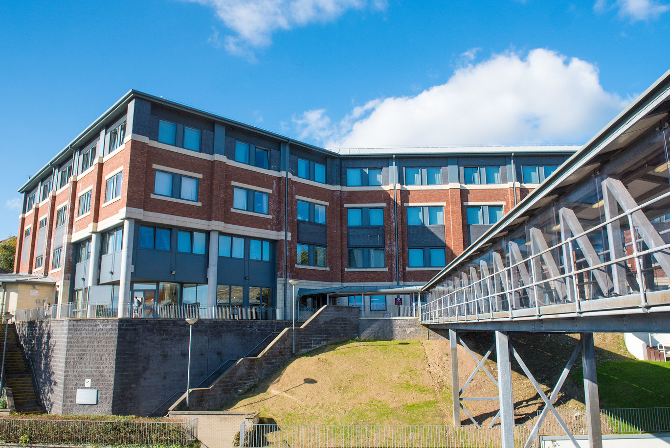 "Strand Road Campus Northland Building with grassy hill at front and raised walkway to right"
