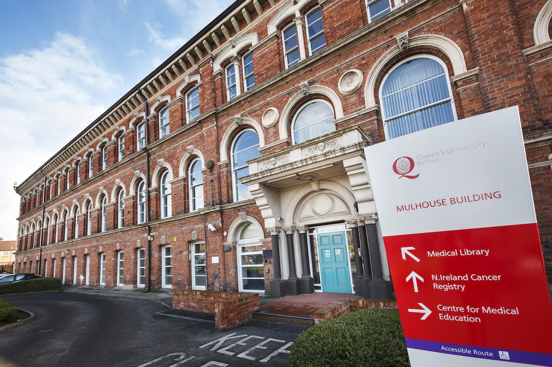 "Mulhouse building with red and white sign in the foreground"