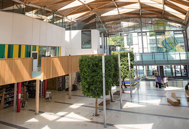The inside of a University Hub building, tiled flooring and multi storey