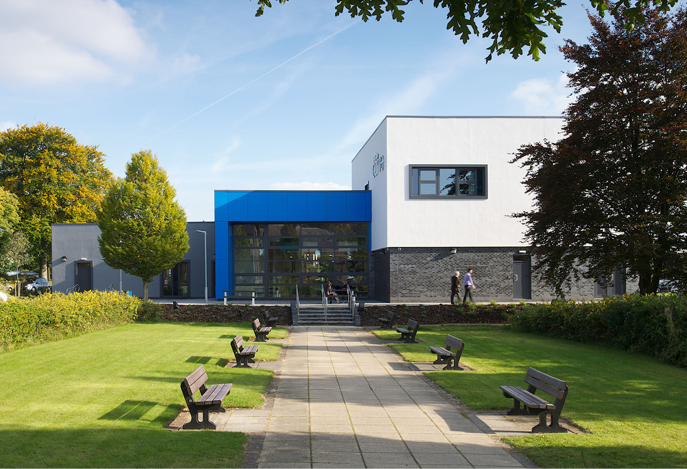 Photo of lead up to main entrance of a Trust building with seating available