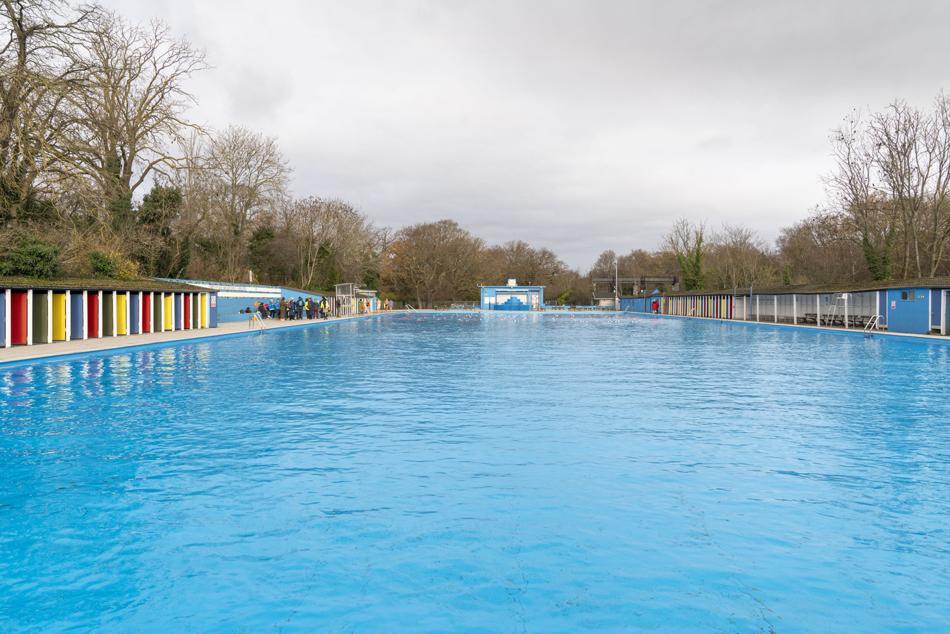 Tooting bec lido, changing huts reflected on the water.