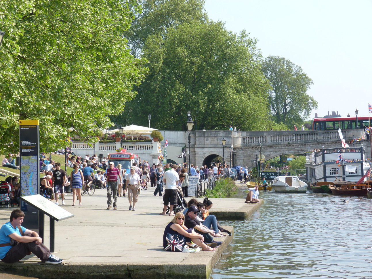 "People sitting by the riverside"