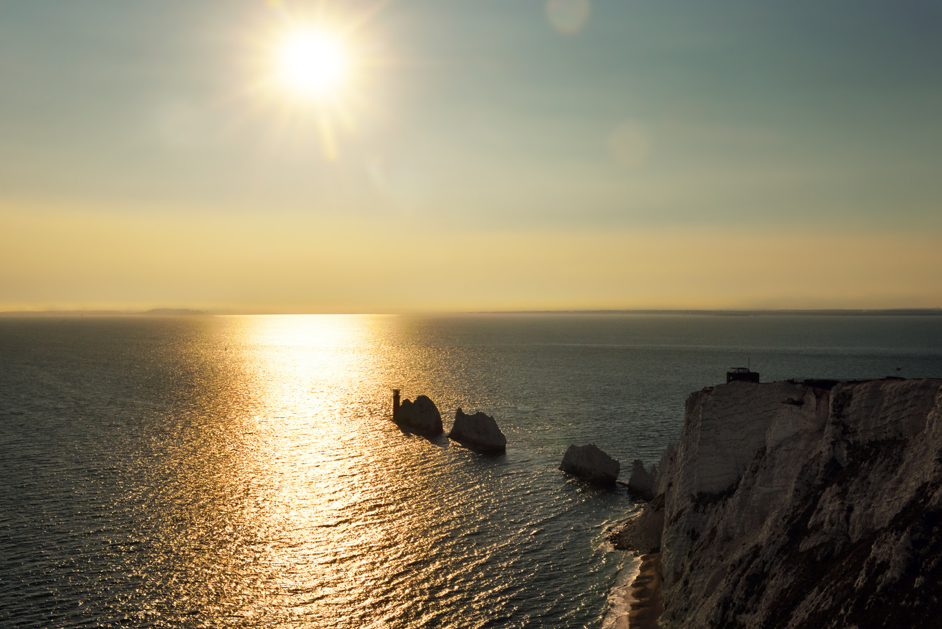 Aerial view of the Needles and Headland at the Needles Old Battery and New Battery in the evening sun reflected in the sea.