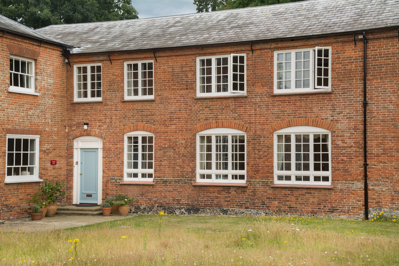 The exterior of the brick built The Squire's Retreat with lawns out the front.