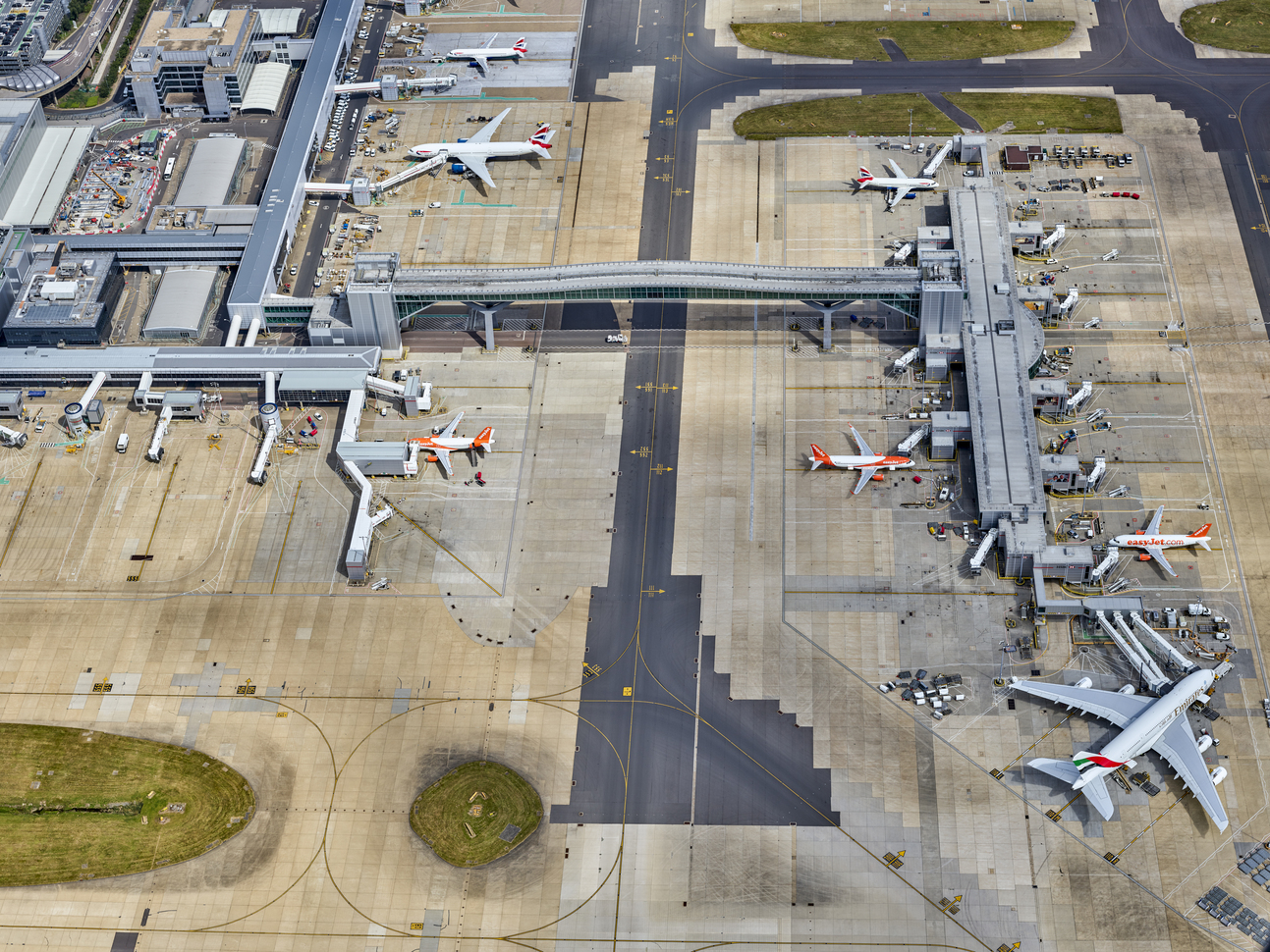 "Aerial view of aero planes parked at a terminal"