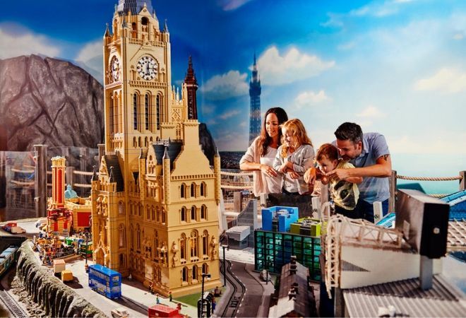 "family looking at lego"