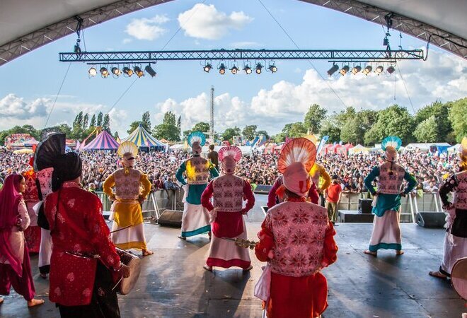 A colourful performance in front of a large crowd 