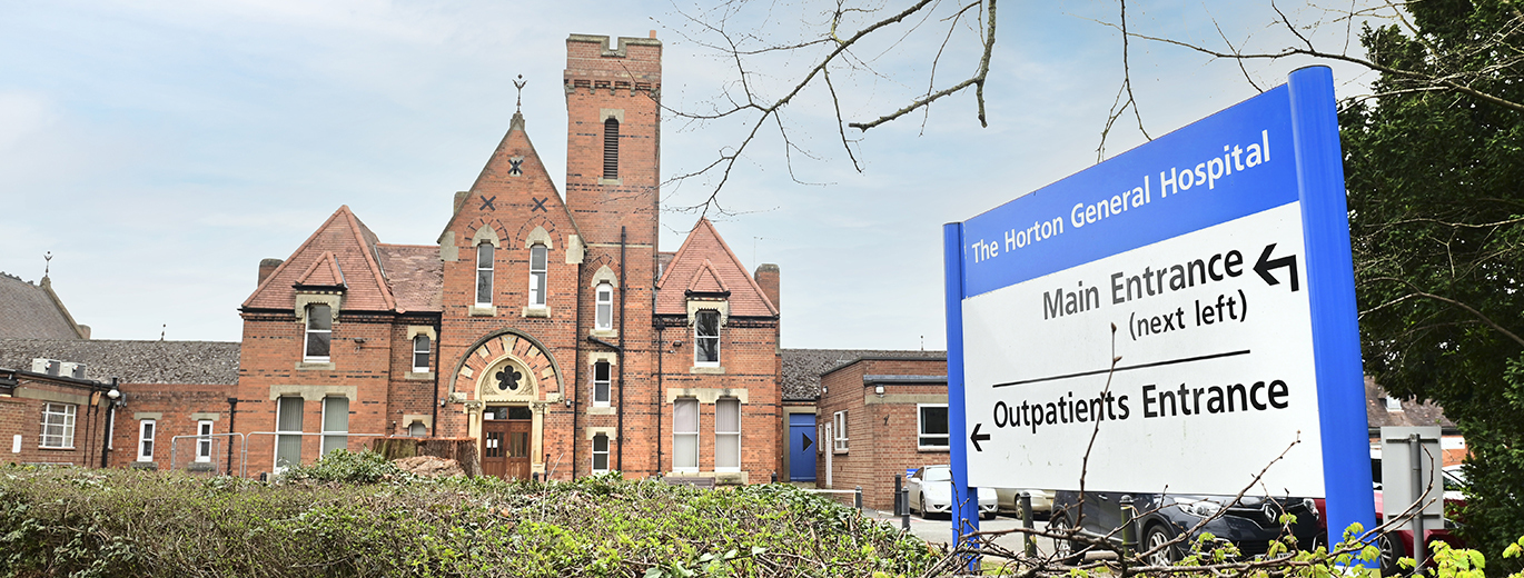"The Horton General Hospital with entrance signs in foreground"