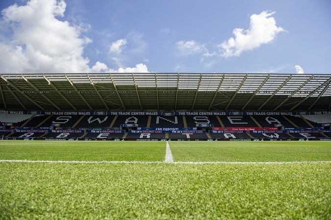 'Swansea City Football Pitch, image of the main stand showing Swansea in writing'