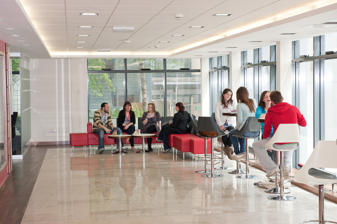 "Students in communal area interacting with each other"