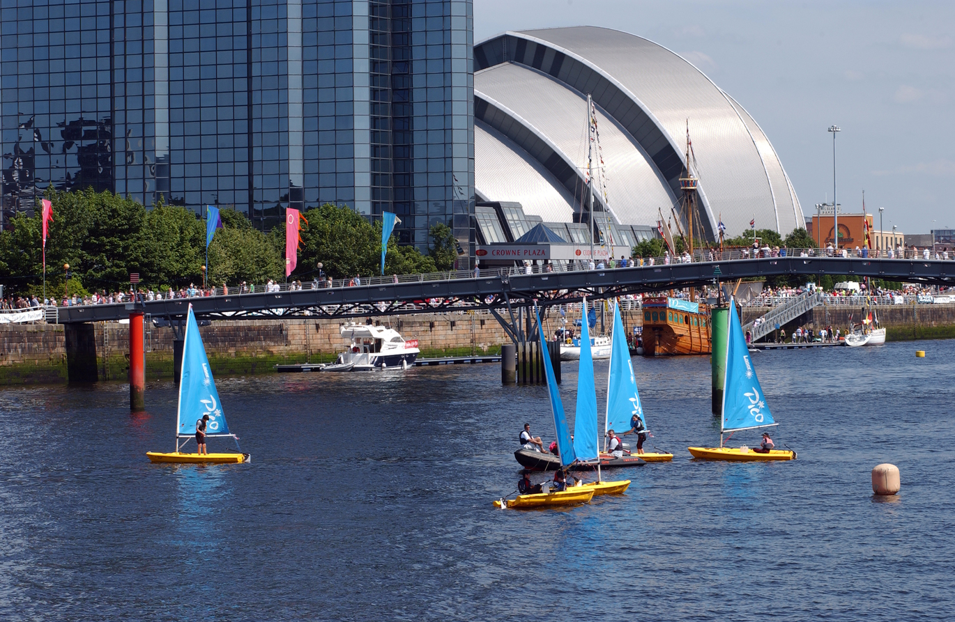 "River Clyde with Armadillo in background and people windsurfing on river"