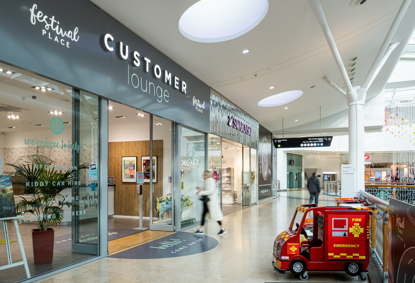 "Image shows the frontages of shops in the centre including Swarowski and the Customer Service Lounge"