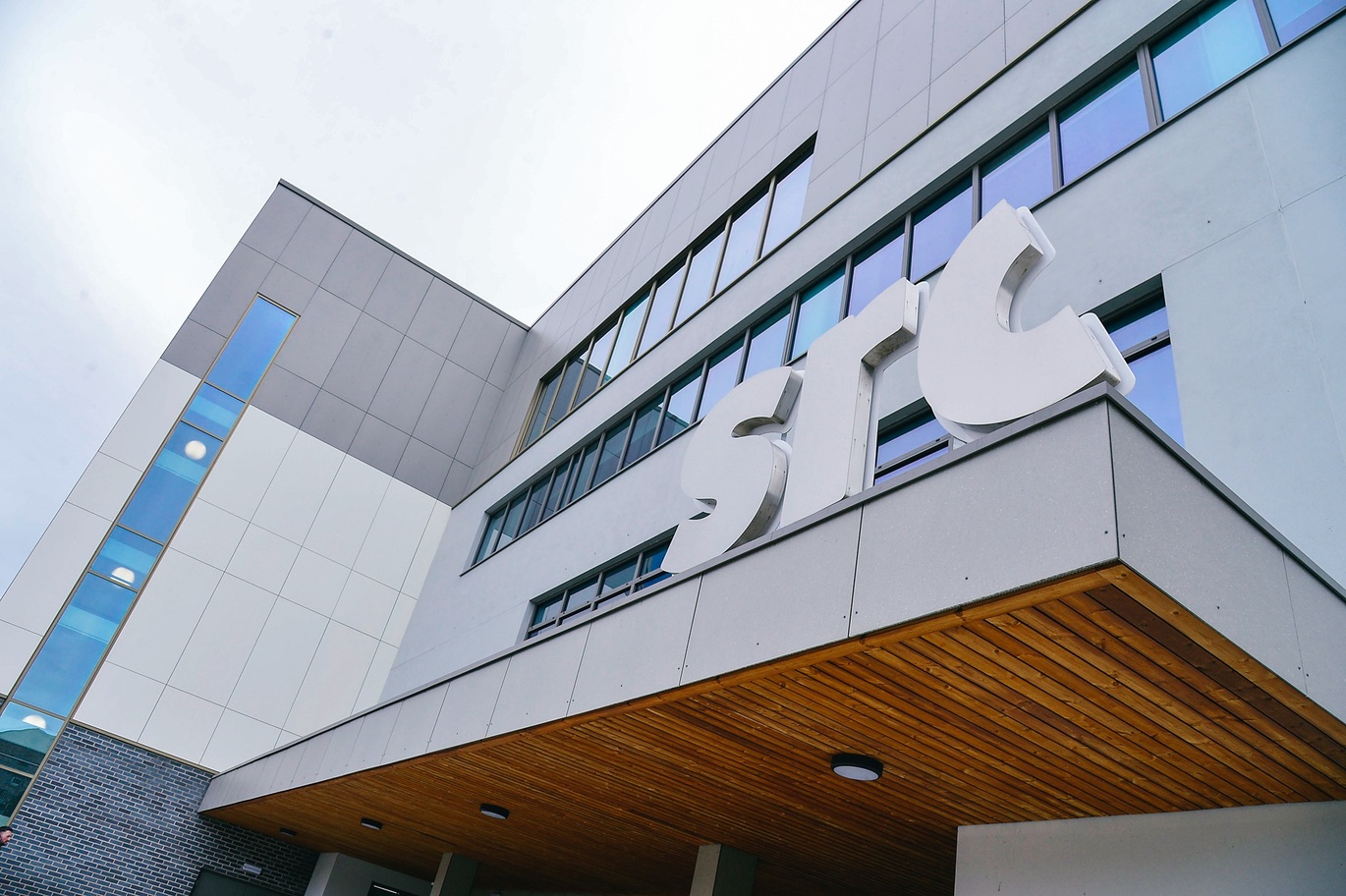 "Exterior of Newry Campus building which is mostly silver against a small piece of cloudy sky"