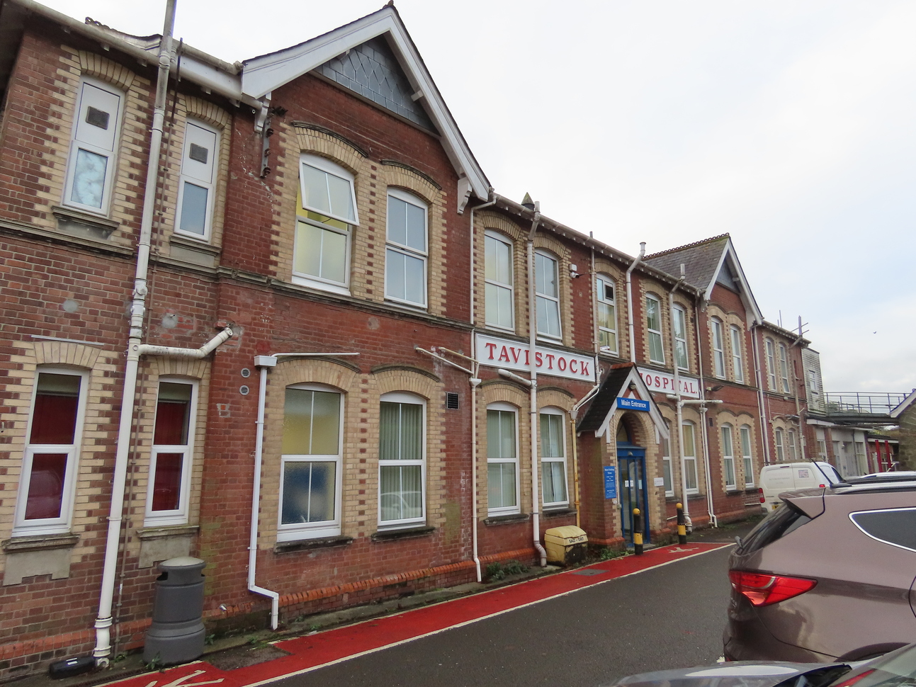 red brick building with blue door and red pedestrian area 