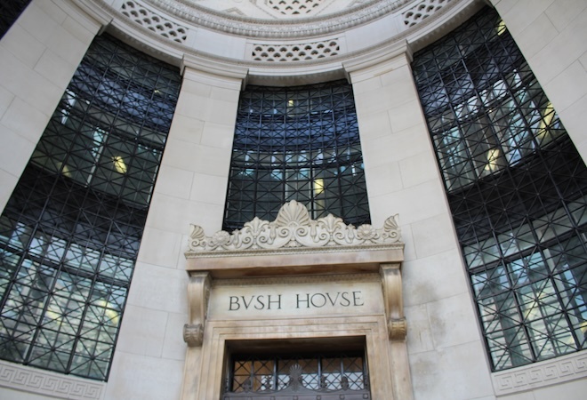 "Interior image of a rounded white walled University building with large rectangular windows"