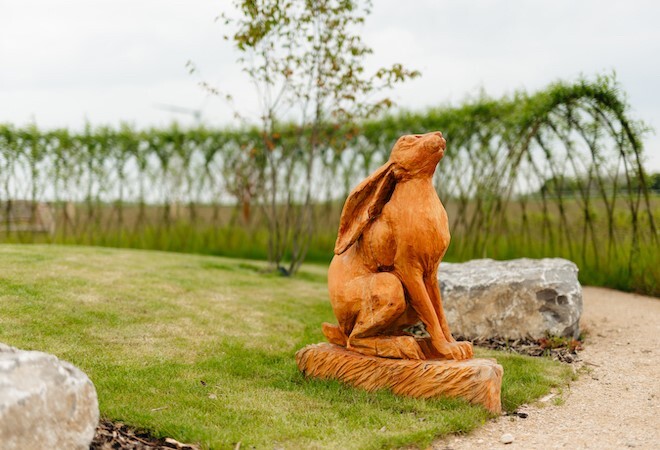 "Image of a stone hare memorial within the gardens at the crematorium"