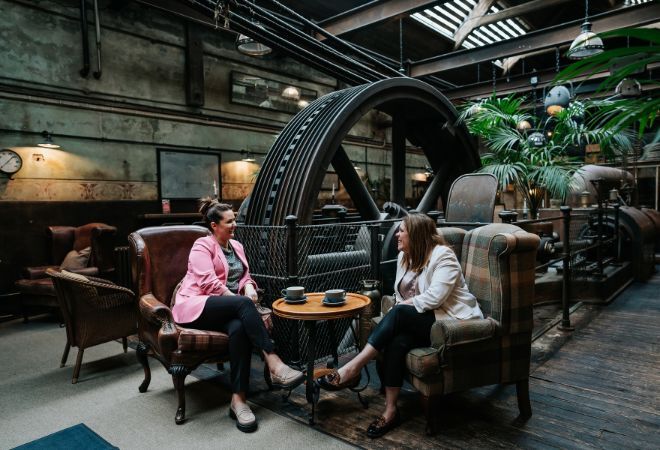 Two people chatting in a coffee shop