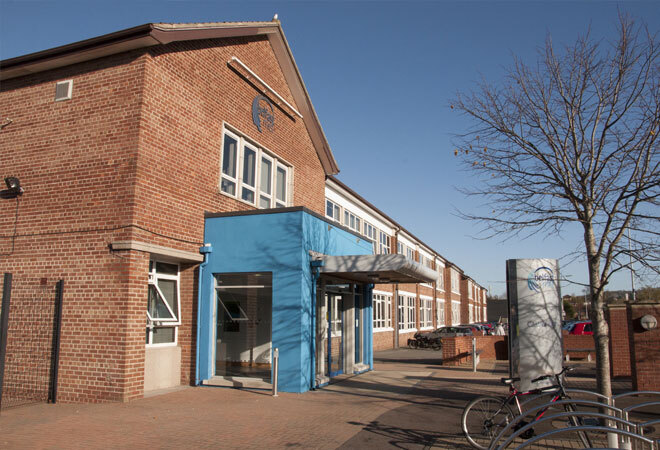 "Exterior image of red brick building with blue sky in background"