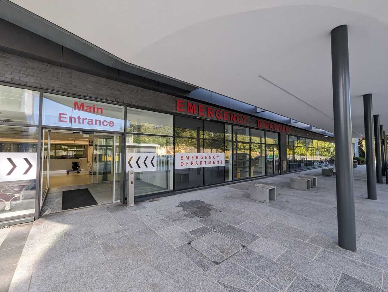 "The Emergency Department main entrance at Ulster Hospital. There are automatic glass doors and above them is a sign in red letters saying 'Main Entrance'. To the right of the doors there is glass panelling and a further set of double automatic doors. Above there is red signage reading 'Emergency Department'."