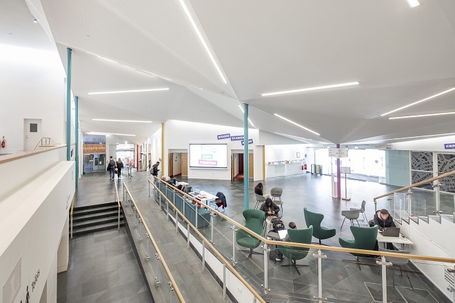 "Photo of atrium area with seating and desks available."
