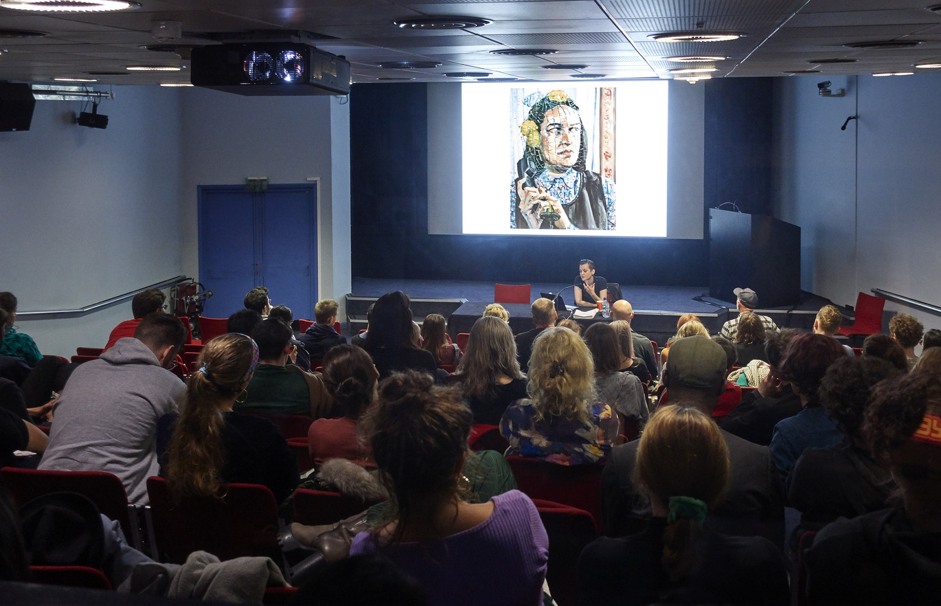 "Back of a Lecture Theatre looking over students towards the stage"