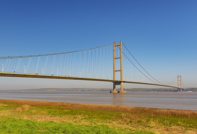 humber bridge with a beautiful blue sky, not a cloud in site and the tide is out.