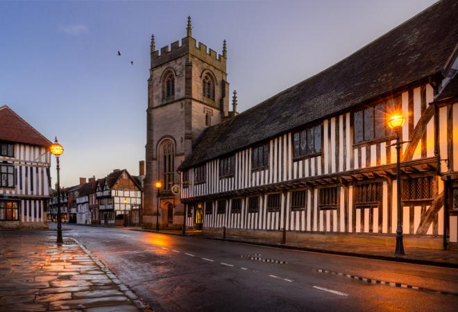 "Outside view of Shakespeare's Schoolroom, a Tudor style building, at dusk"