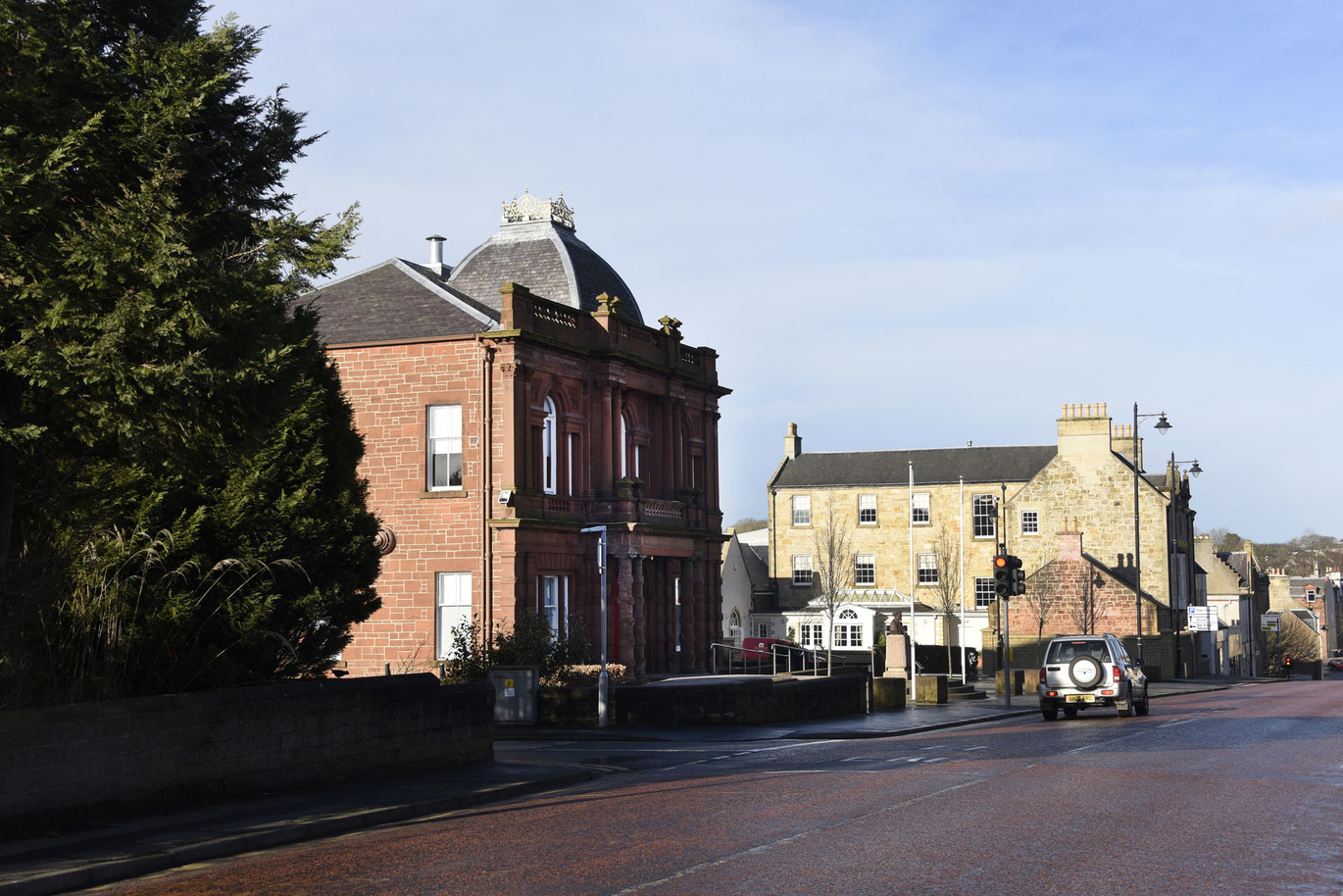 "East Ayrshire Town street view. Street lined with large traditional buildings."