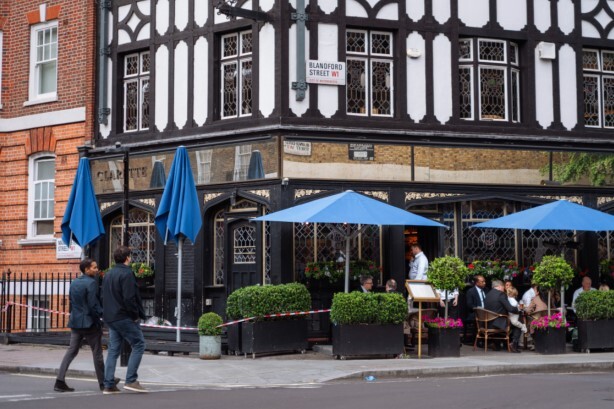 Clarette, photo from outside of the pub, customers enjoying a beer.